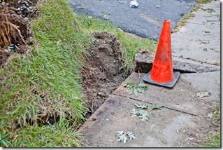 storm damage in Bowie MD, damaged sidewalk and orange cone