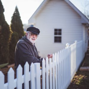 man leaning on a fence