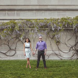 panorama of couple in front of flowers